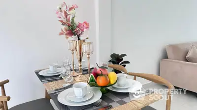 Elegantly set dining table in a modern minimalist living space with natural light, perfect for intimate meals and entertaining guests.