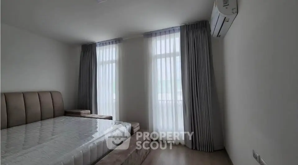 Spacious bedroom with modern design and large windows for natural light