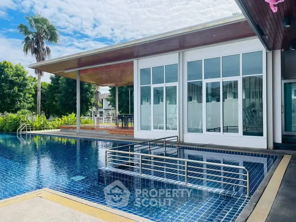 Luxurious modern house with stunning pool and lush greenery, perfect for relaxation and entertainment.