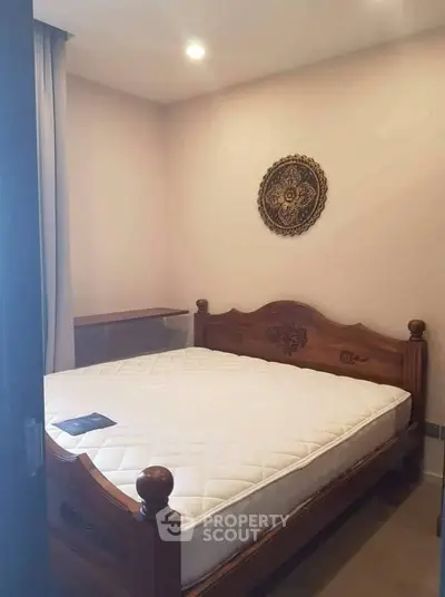 Cozy bedroom with wooden bed frame and elegant wall decor