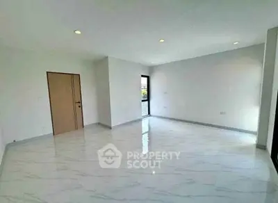 Spacious empty room with marble flooring and natural light, ideal for customization.