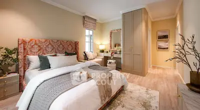 Luxurious bedroom with elegant decor and cozy ambiance, featuring a plush bed and stylish furnishings.