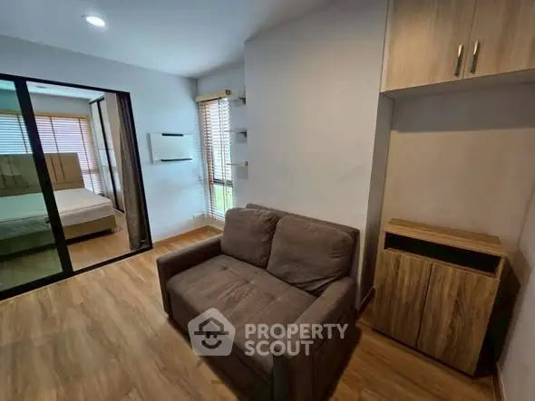 Modern living room with cozy sofa and wooden flooring in stylish apartment