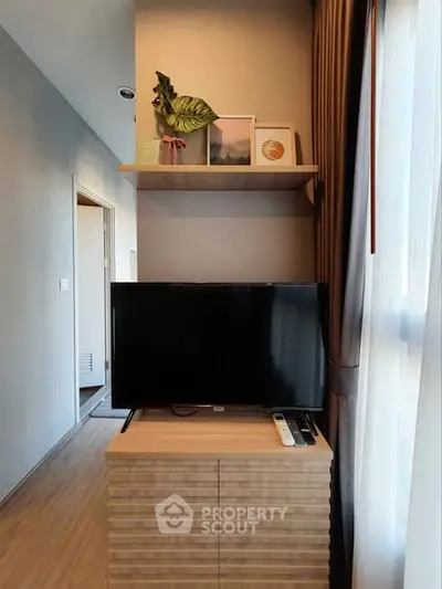 Modern living room with sleek TV stand and decorative shelving, perfect for stylish urban living.