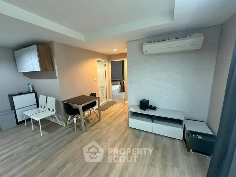 Modern living room with sleek furniture and air conditioning, perfect for urban living.