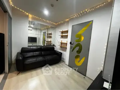 Modern living room with sleek black sofa and decorative lighting