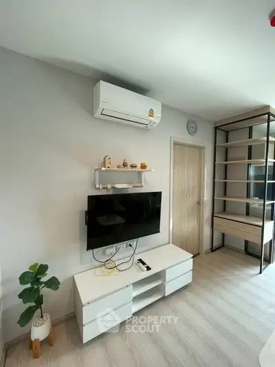 Modern living room with sleek furniture and air conditioning, perfect for comfortable living.