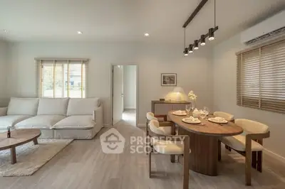 Spacious modern living room with elegant dining area and cozy seating.