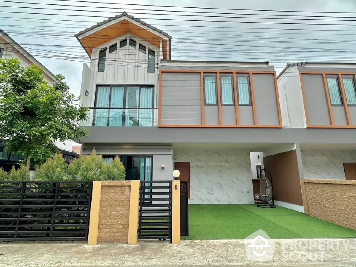 Modern two-story house with stylish facade and spacious front yard