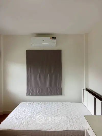 Minimalist bedroom with air conditioning and simple decor