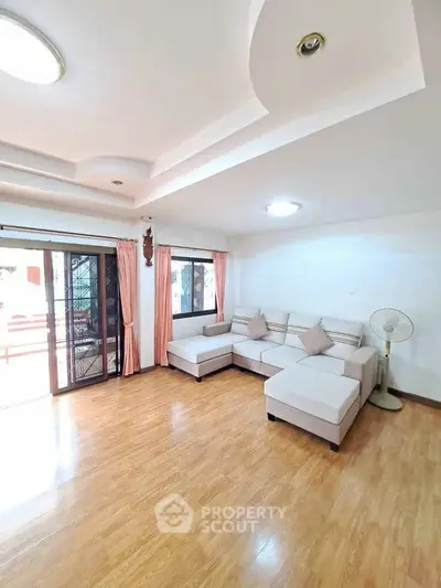 Spacious living room with elegant ceiling design and cozy corner sofa