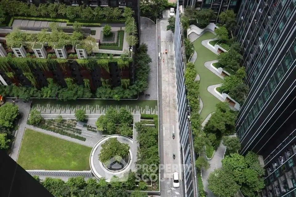 Stunning aerial view of modern urban garden with lush greenery and sleek architecture.