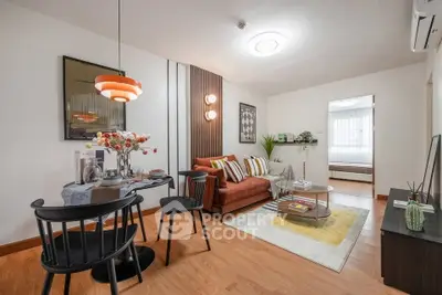 Stylish living room with modern decor and cozy seating area in a contemporary apartment.