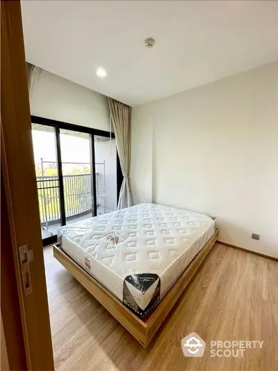 Spacious bedroom with large windows and ample natural light, featuring a fresh, modern design and a cozy ambiance, perfect for relaxation and comfort.