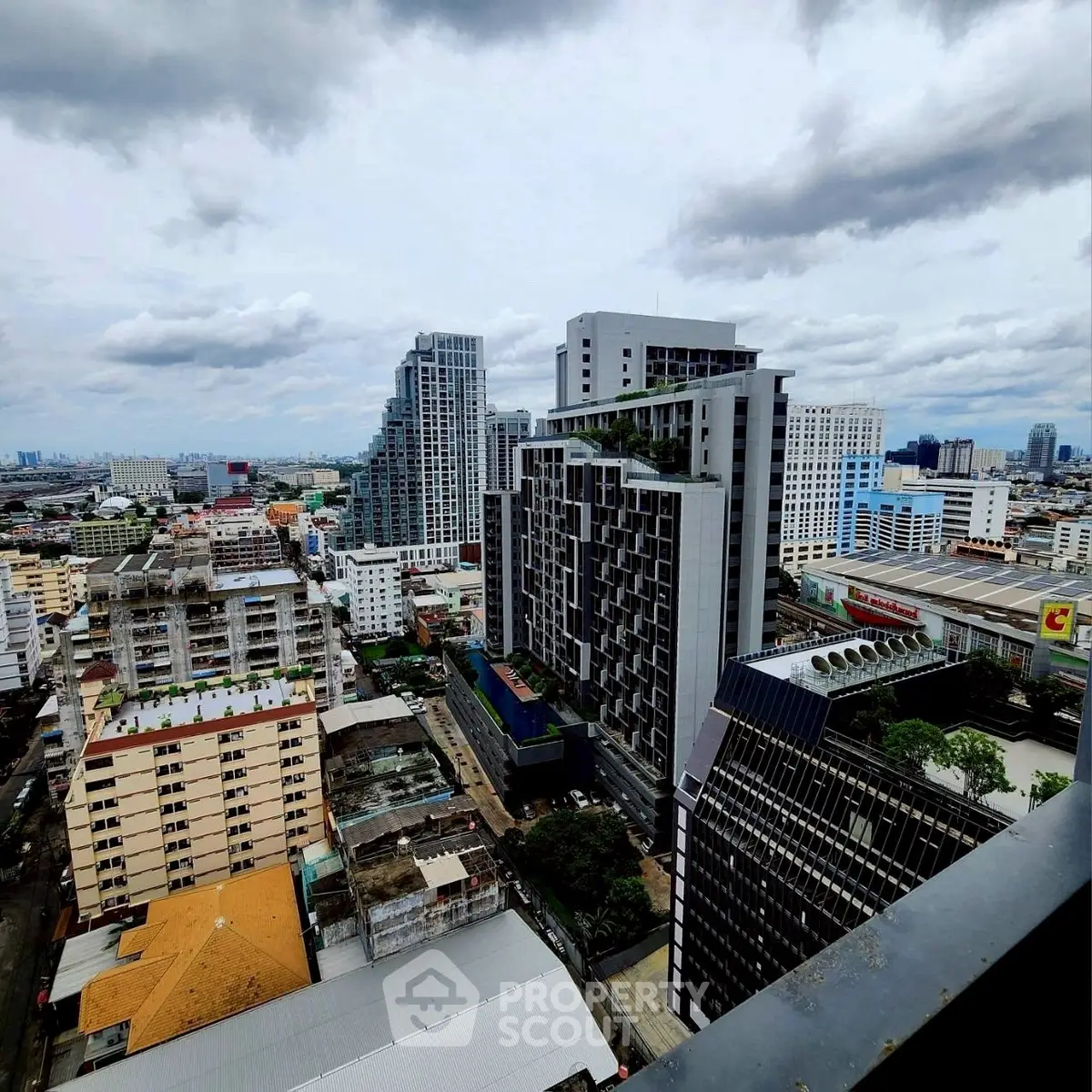 Stunning cityscape view from high-rise balcony showcasing modern urban architecture.