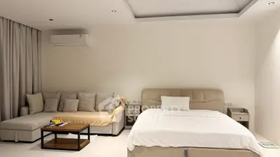 Spacious modern bedroom with cozy seating area and minimalist decor