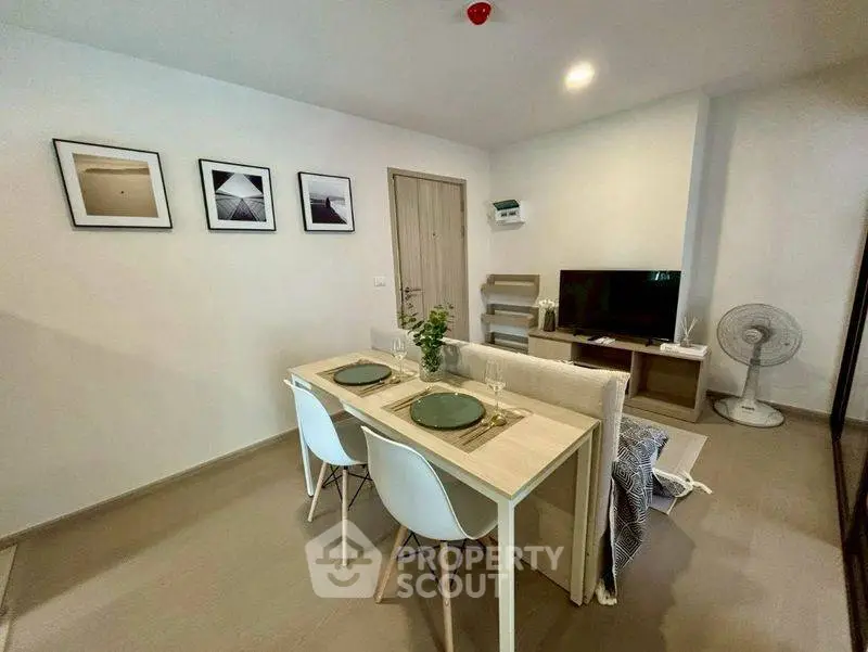 Modern living room with dining area, stylish decor, and cozy ambiance in a contemporary apartment.