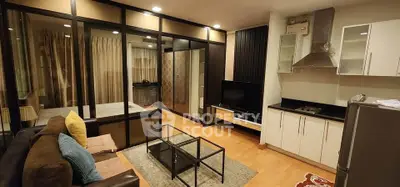 Modern living room with open kitchen and stylish glass partition