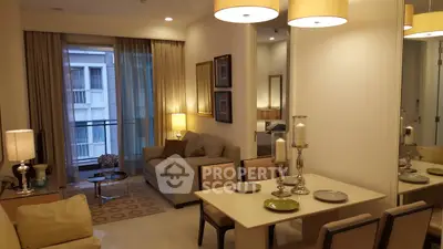 Elegant living room with modern decor and dining area, featuring warm lighting and a cozy ambiance.