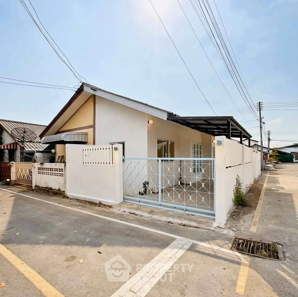 Charming single-story home with gated entrance and spacious driveway in a peaceful neighborhood.