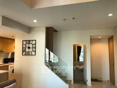 Modern duplex apartment with stylish staircase and open kitchen layout