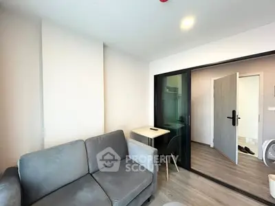 Modern living room with sleek gray sofa and sliding glass door