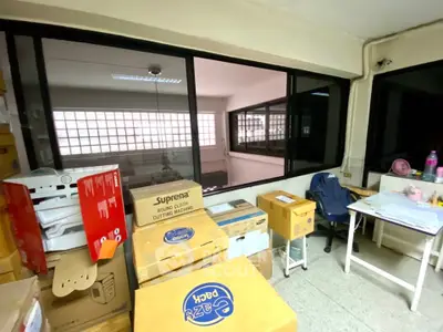 Spacious storage room with ample natural light and organized boxes, ideal for efficient organization.