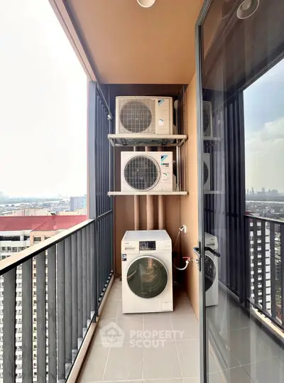 High-rise balcony with washing machine and city view, perfect for urban living.