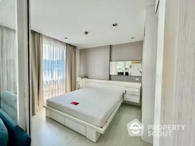 Spacious bedroom with modern design, ample natural light, and integrated living space, featuring a large bed and sleek furnishings.