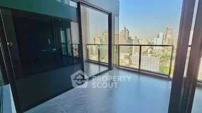 Spacious balcony with stunning city skyline view in modern high-rise apartment.
