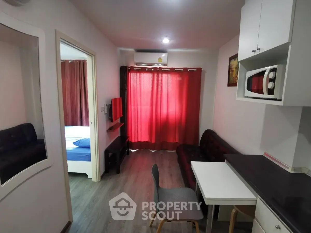 Cozy apartment with modern furnishings and open layout, featuring a compact kitchen and inviting living area.