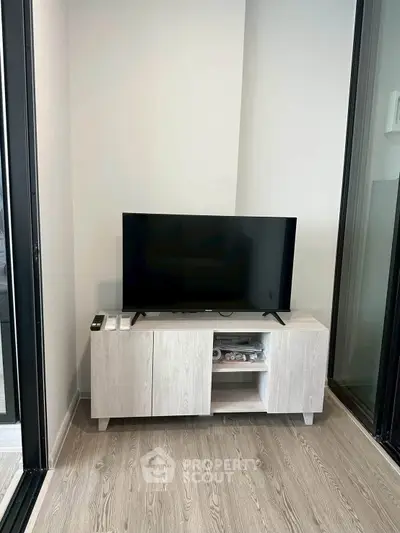 Modern living room corner with sleek TV stand and flat-screen TV, perfect for cozy entertainment.
