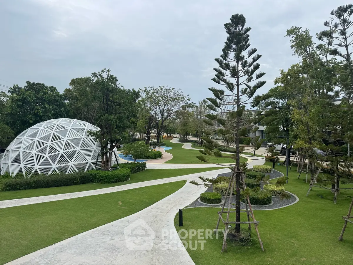 Stunning landscaped garden with modern architectural dome and lush greenery in a serene residential area.