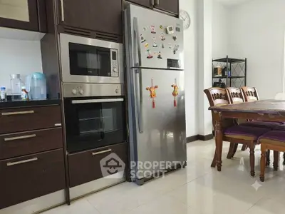 Modern kitchen with stainless steel appliances and dining area