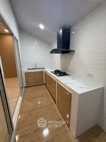 Modern kitchen with sleek design, featuring gas stove and ample counter space.
