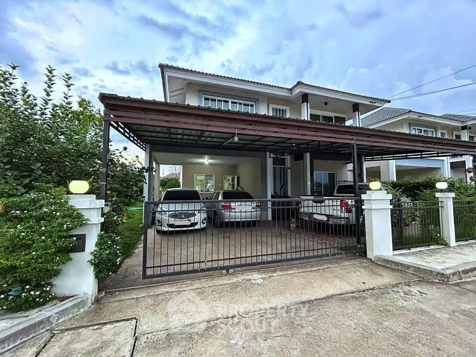 Spacious two-story house with covered parking and lush greenery in a serene neighborhood.