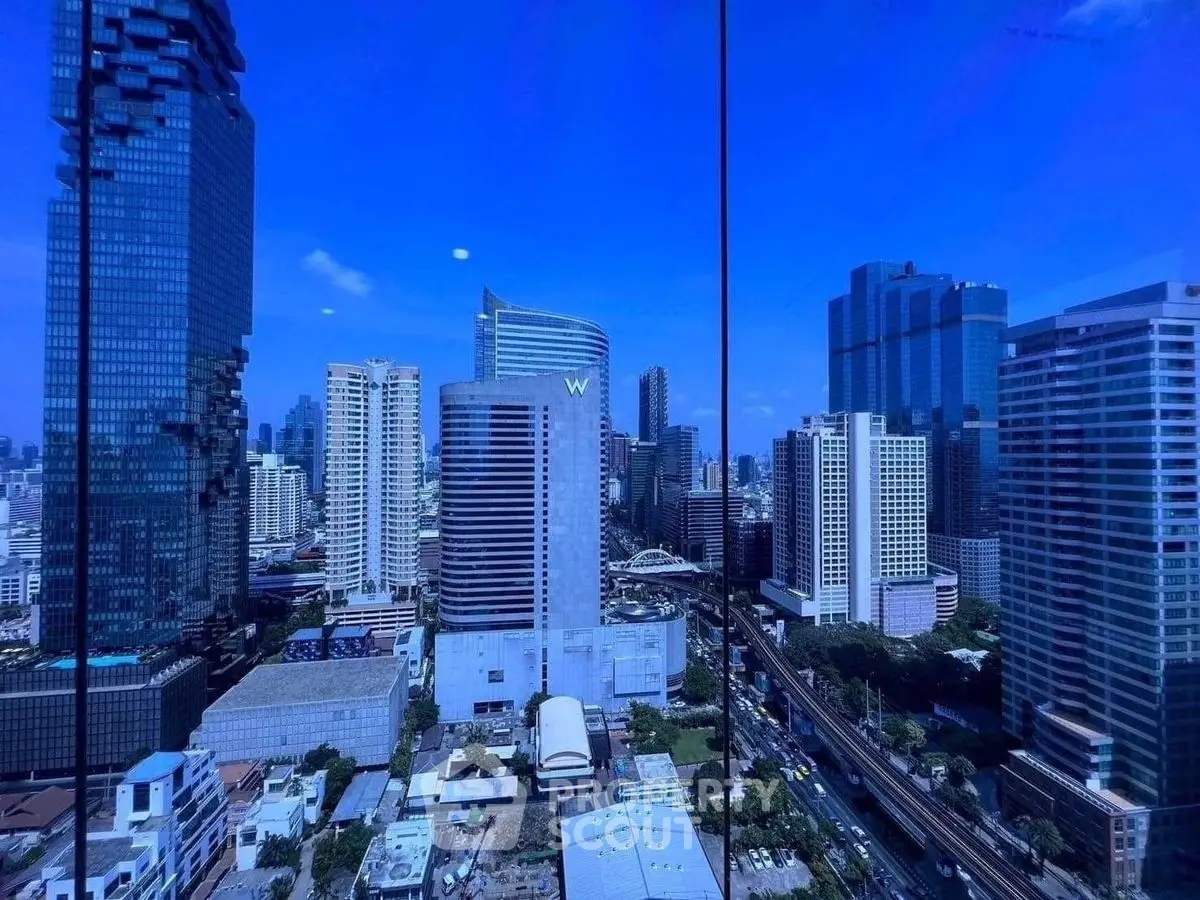 Stunning cityscape view showcasing modern skyscrapers under a clear blue sky, perfect for urban living.