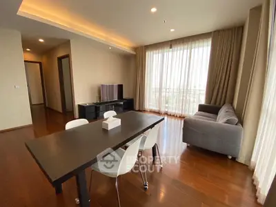 Spacious modern living room with elegant dining area and natural light