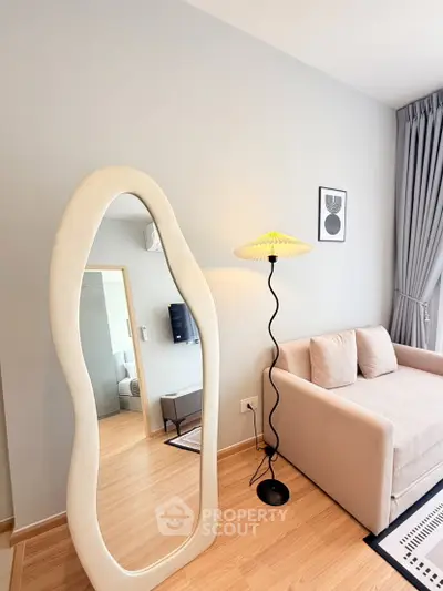 Modern living room with unique mirror and stylish floor lamp