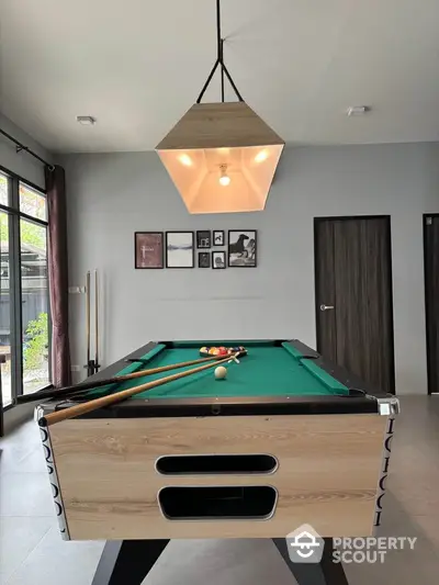 Stylish game room with pool table and modern lighting