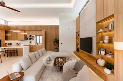 Luxurious modern living room with open kitchen, elegant decor, and ample natural light.