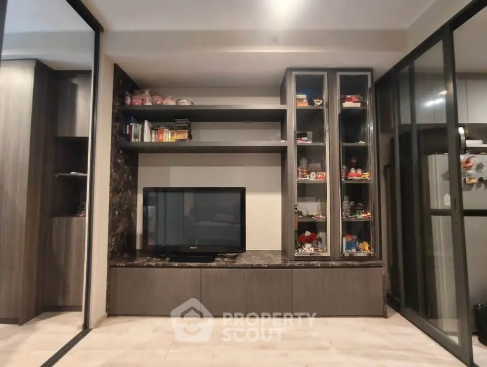 Modern living room with sleek entertainment center and glass sliding doors