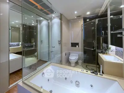 Luxurious modern bathroom with jacuzzi tub and glass shower enclosure