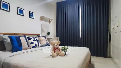 Cozy bedroom with stylish decor and plush teddy bear on bed