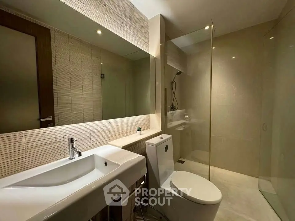 Modern bathroom with sleek fixtures and glass shower enclosure