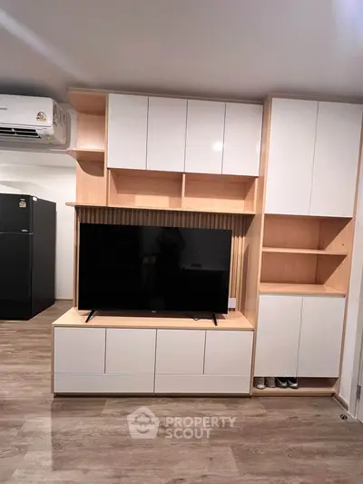 Modern living room with sleek TV unit and ample storage space