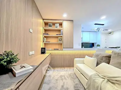 Modern living room with cozy sofa, built-in shelves, and ambient lighting