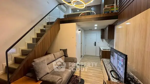 Modern duplex living room with stylish staircase and cozy seating area