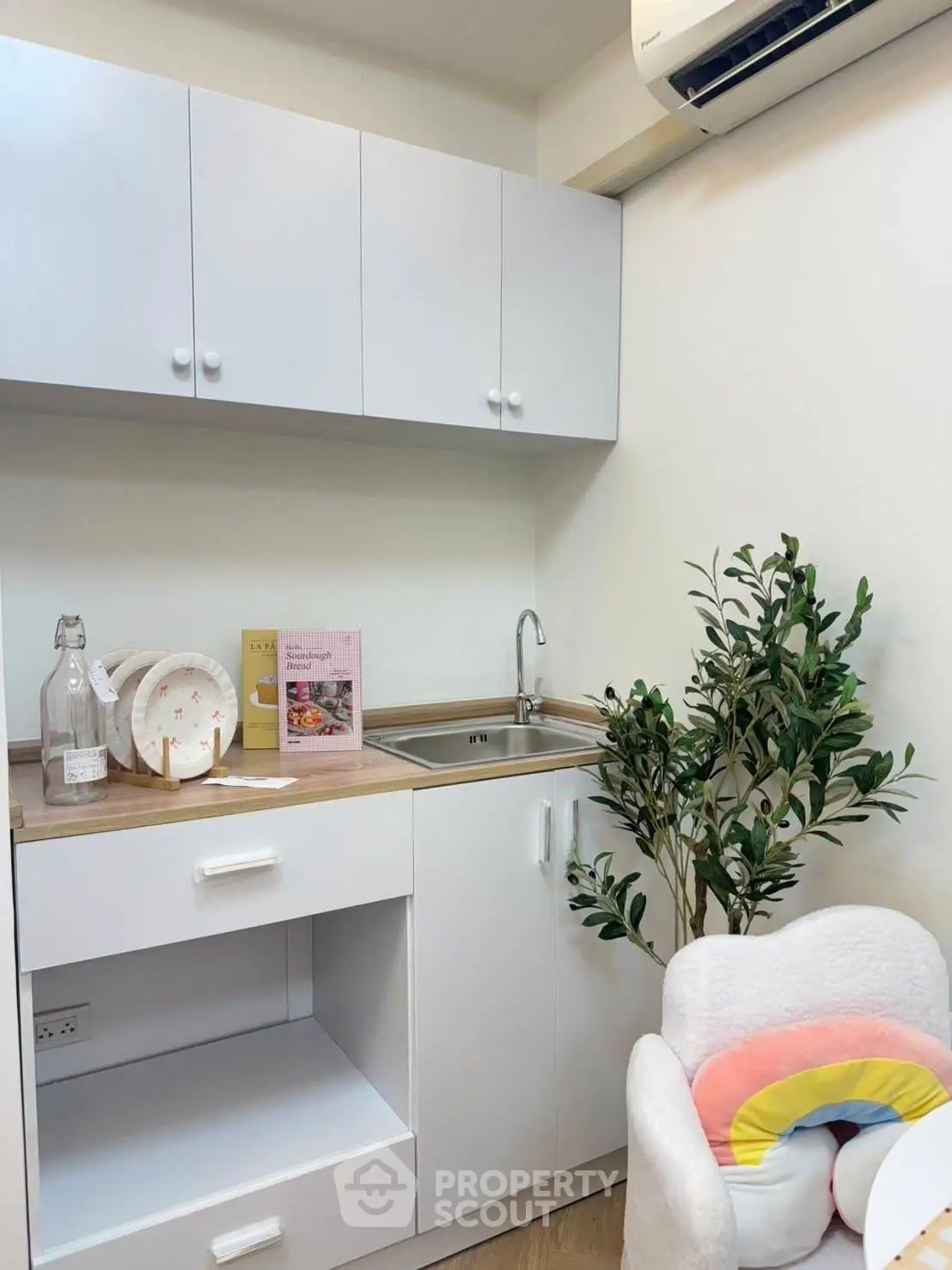 Charming compact kitchen with modern cabinetry and cozy decor