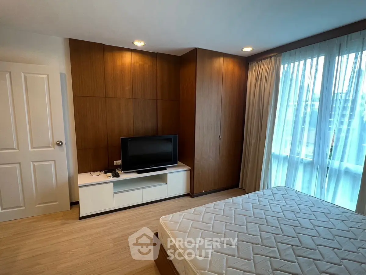Modern bedroom with wooden accents and natural light